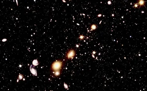 ESA A collection if galaxies in space of various sizes and shapes.