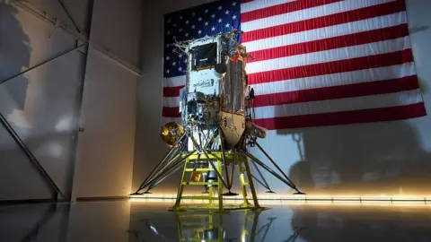 Intuitive Machines A photograph of the Athena spacecraft with six legs. It is about the size of a telephone box